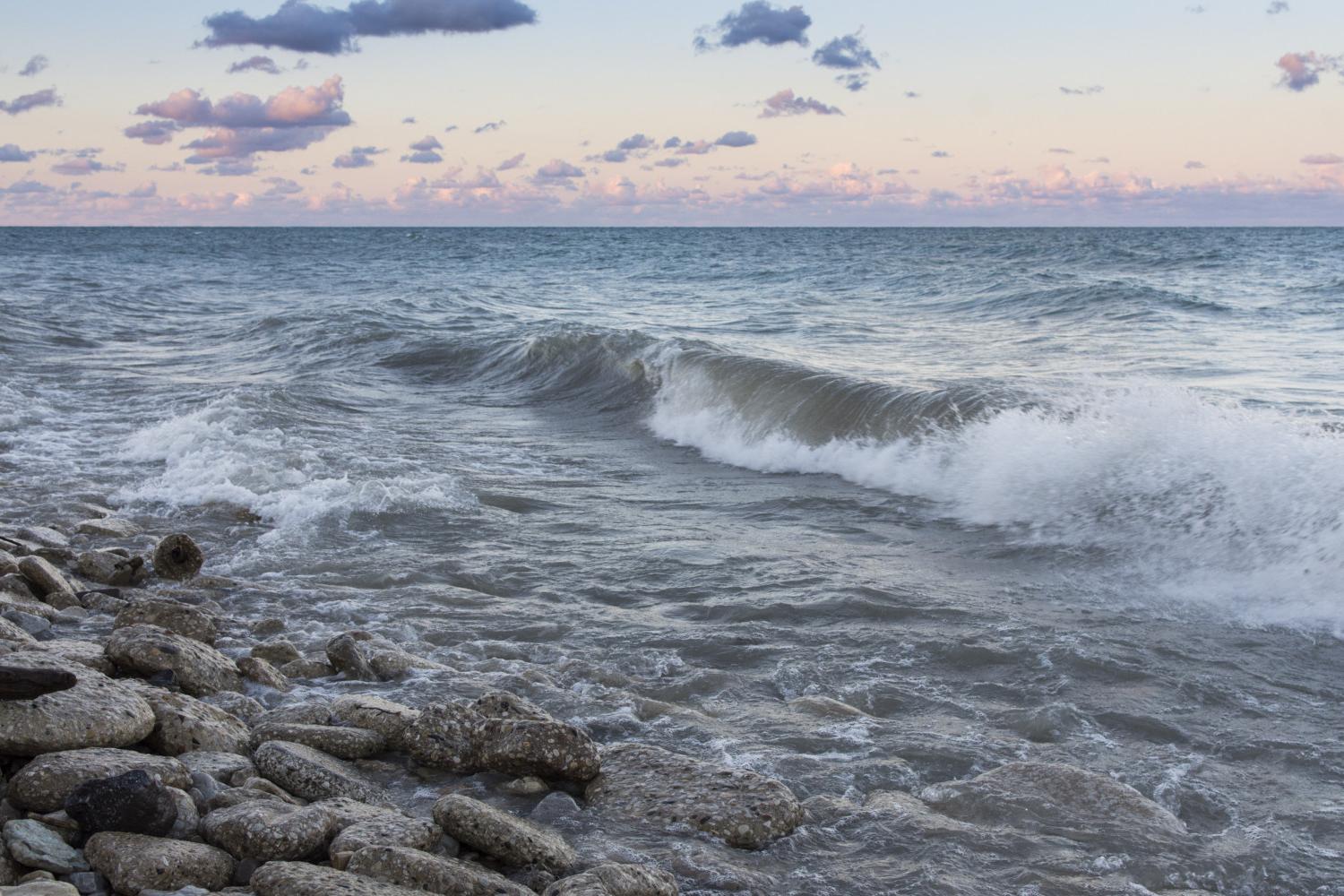 The sun rises over Lake Michigan on the <a href='http://l7cm.vijethaschool.com'>BETVLCTOR伟德登录</a> campus.